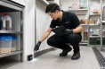 KleanSG pest control technician inspecting a food service area in Singapore
